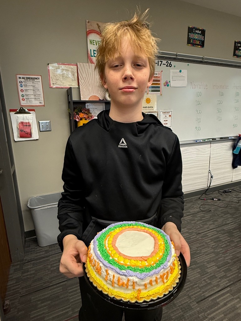 student holding decorated cake