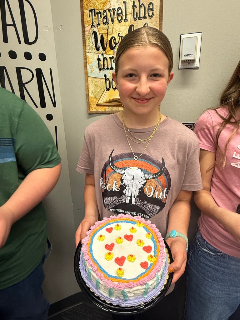 student holding decorated cake