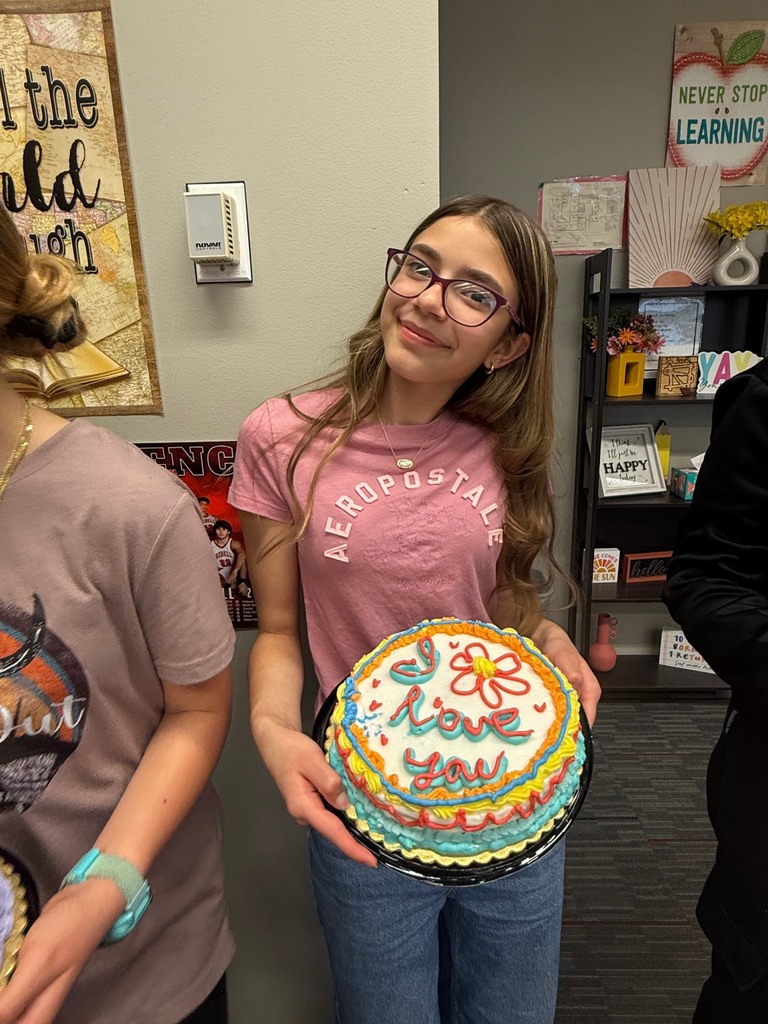 student holding decorated cake