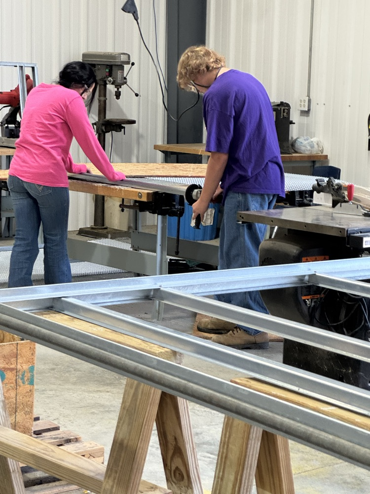 students working on greenhouse tables