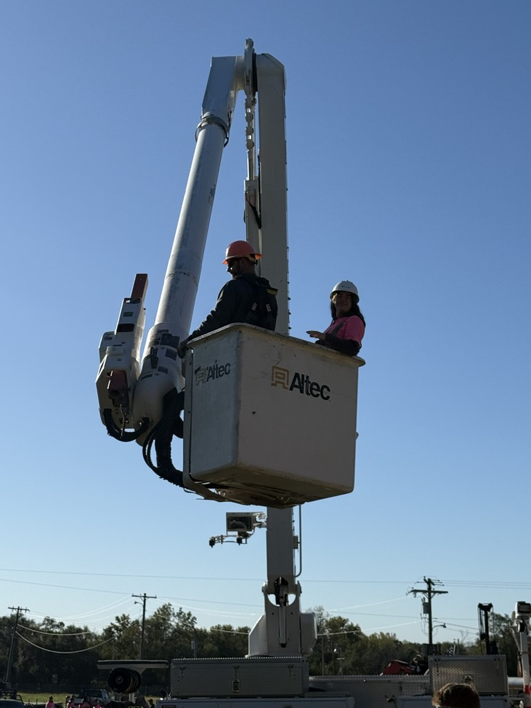 student in a linemans bucket