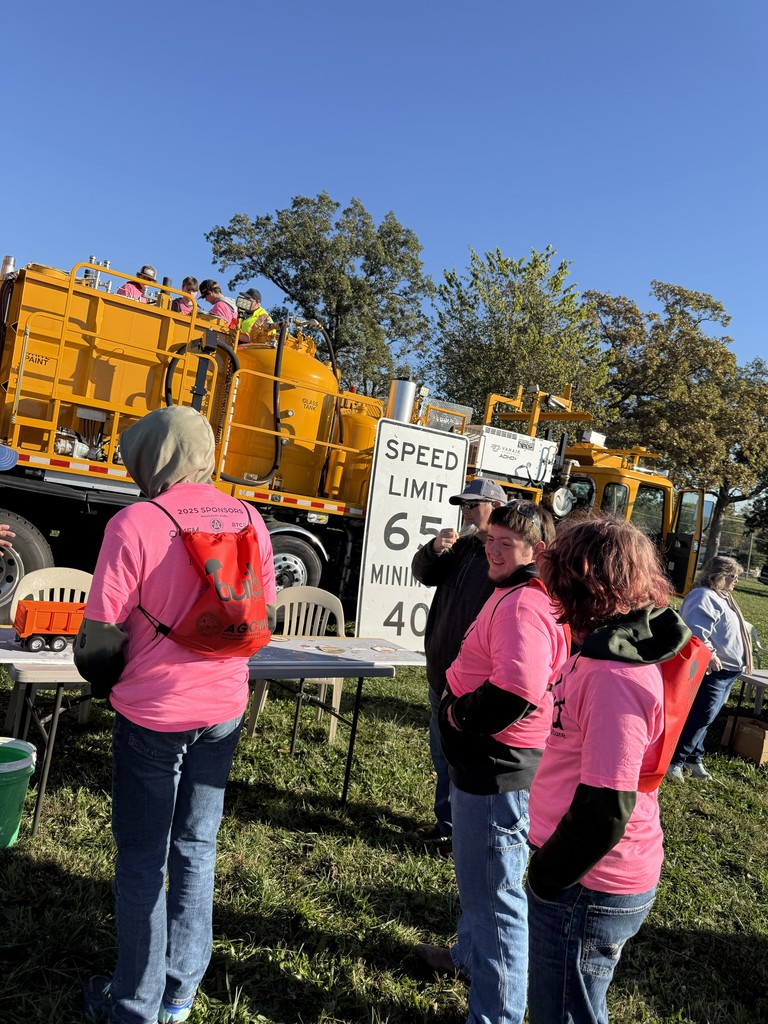 students at roadway construction booth