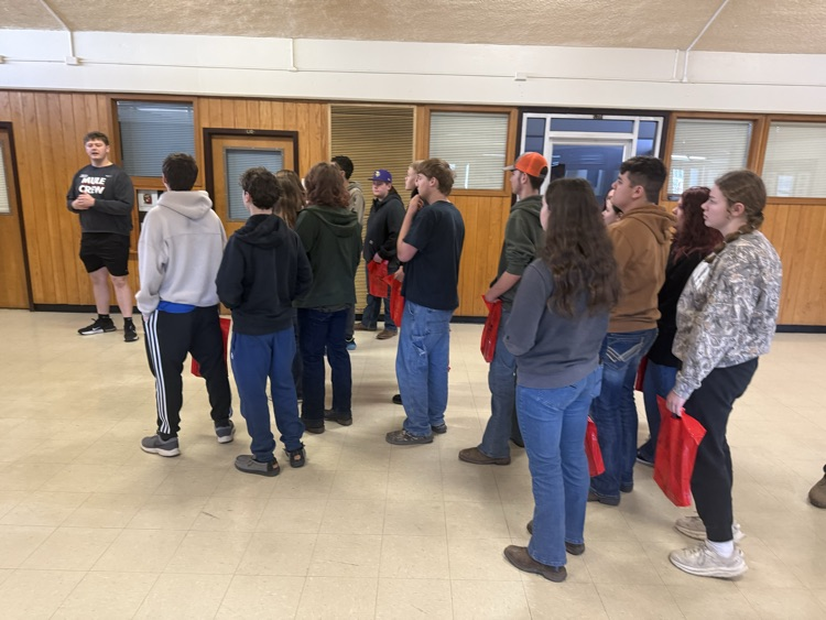 students standing in crowd by speaker