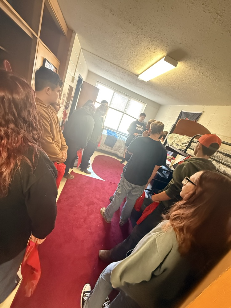 students crowded in dorm room