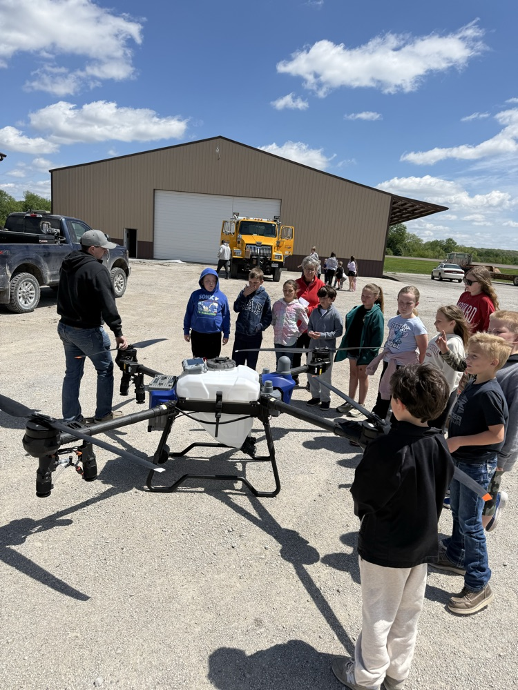 students around spray drone