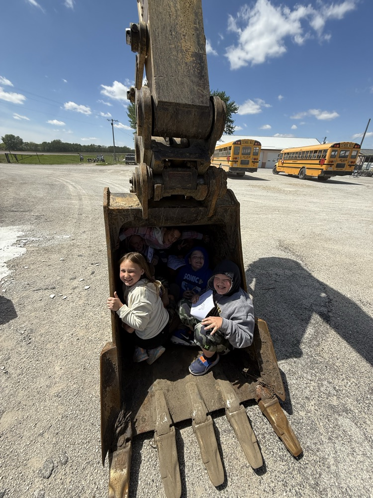 students in bucket of excavator 