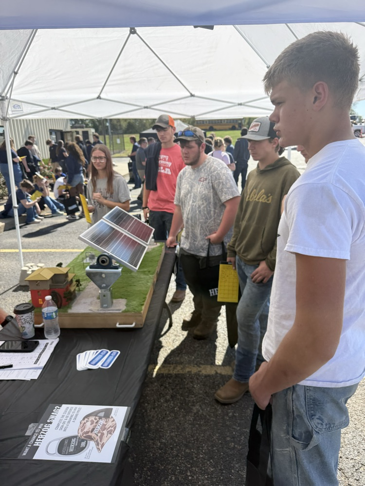 students viewing solar power booth