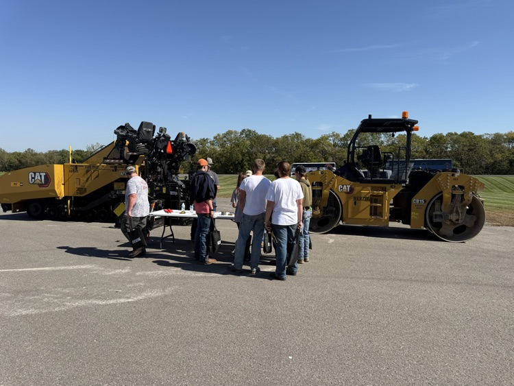 students in front of machinery