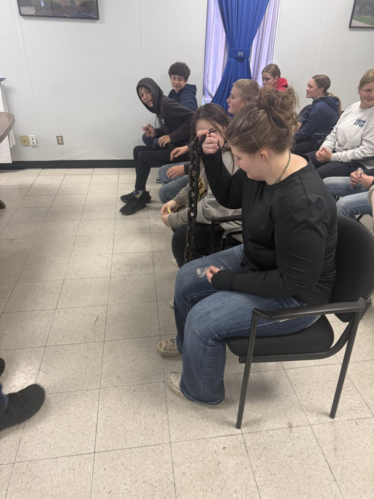 student holding large chain