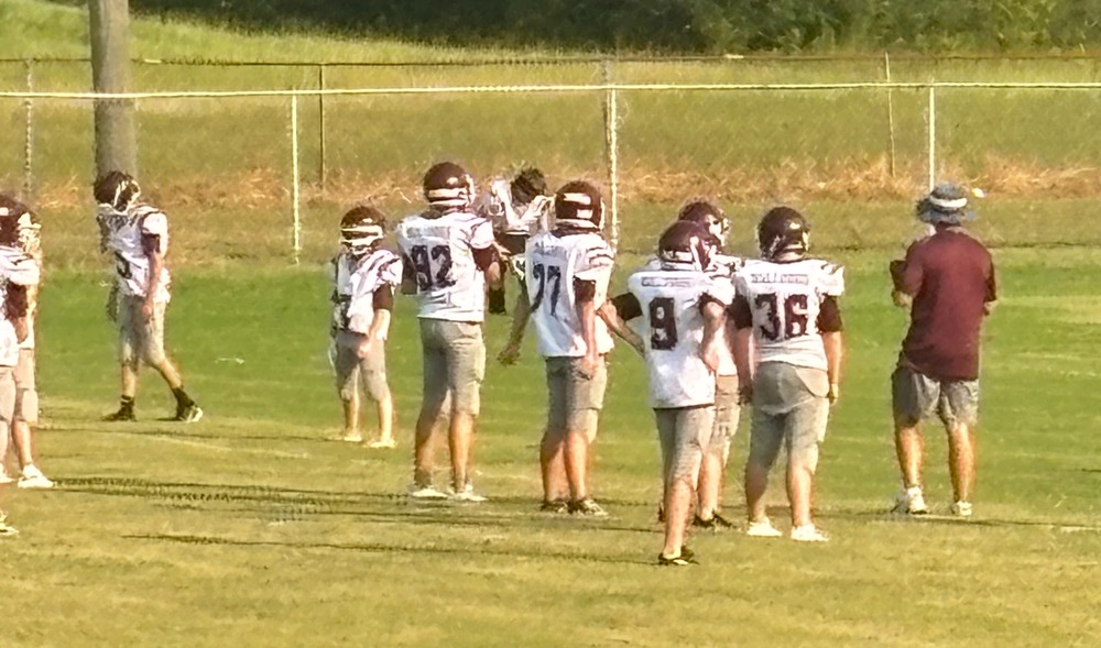 football players standing on field
