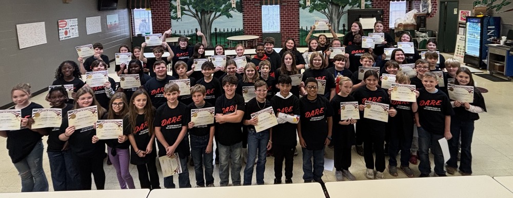group of 5th grade students holding certificates