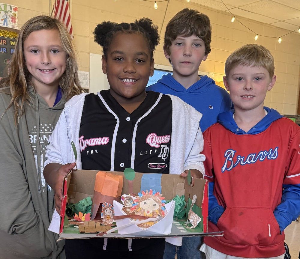 students holding dioramas
