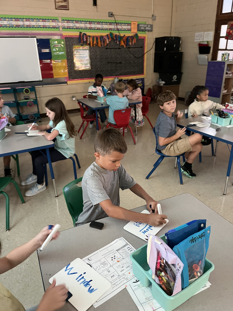 elementary students working at tables