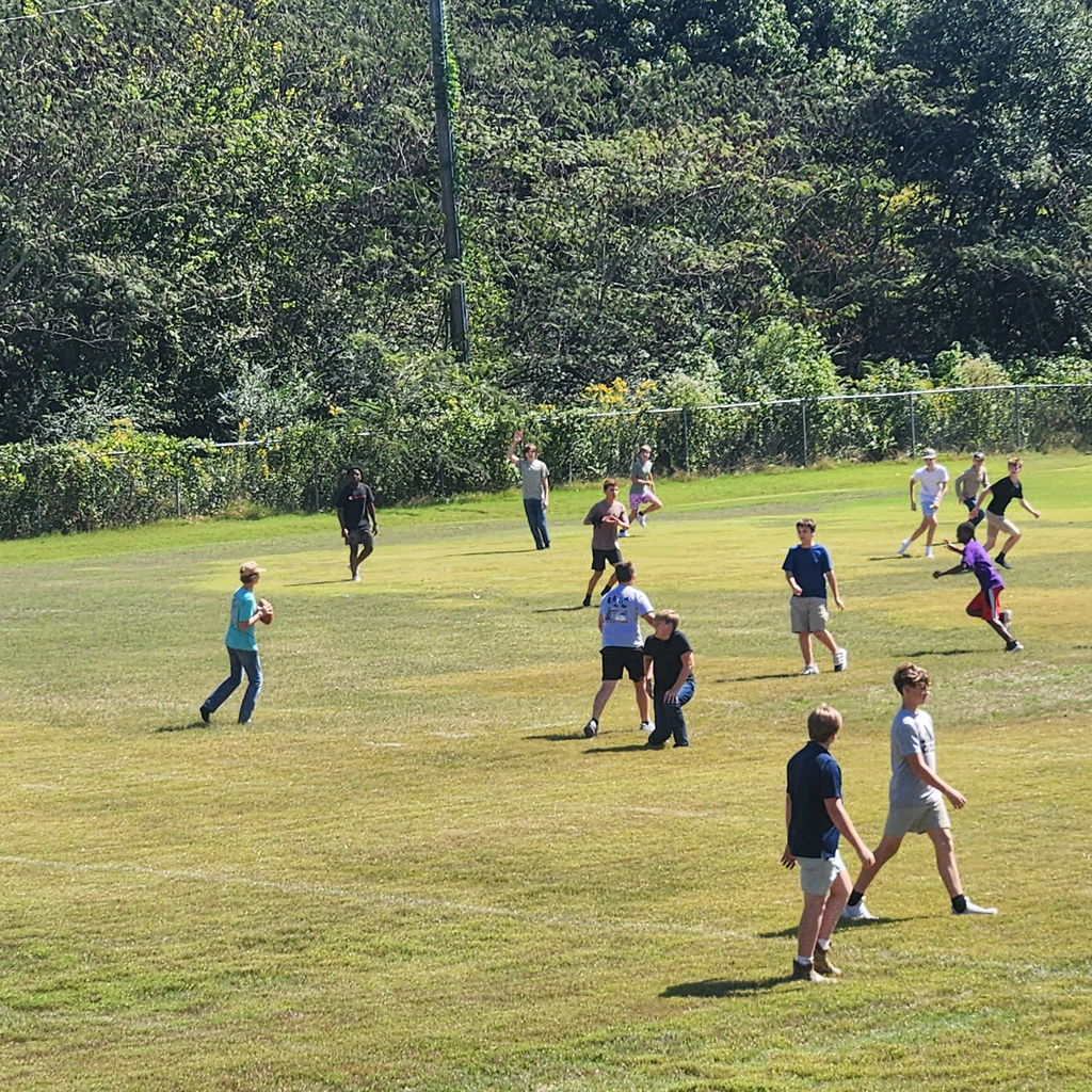 Junior high students mingling on the football field