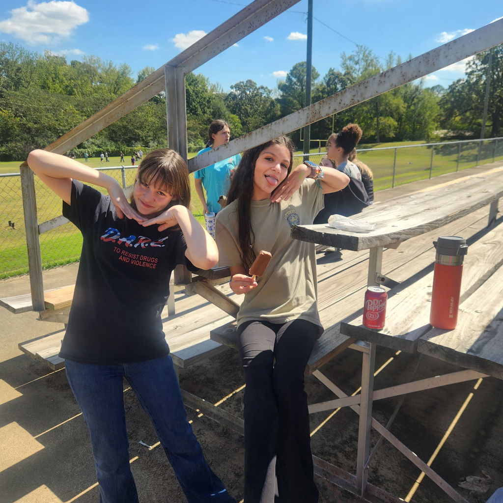 Junior high students mingling on the football field