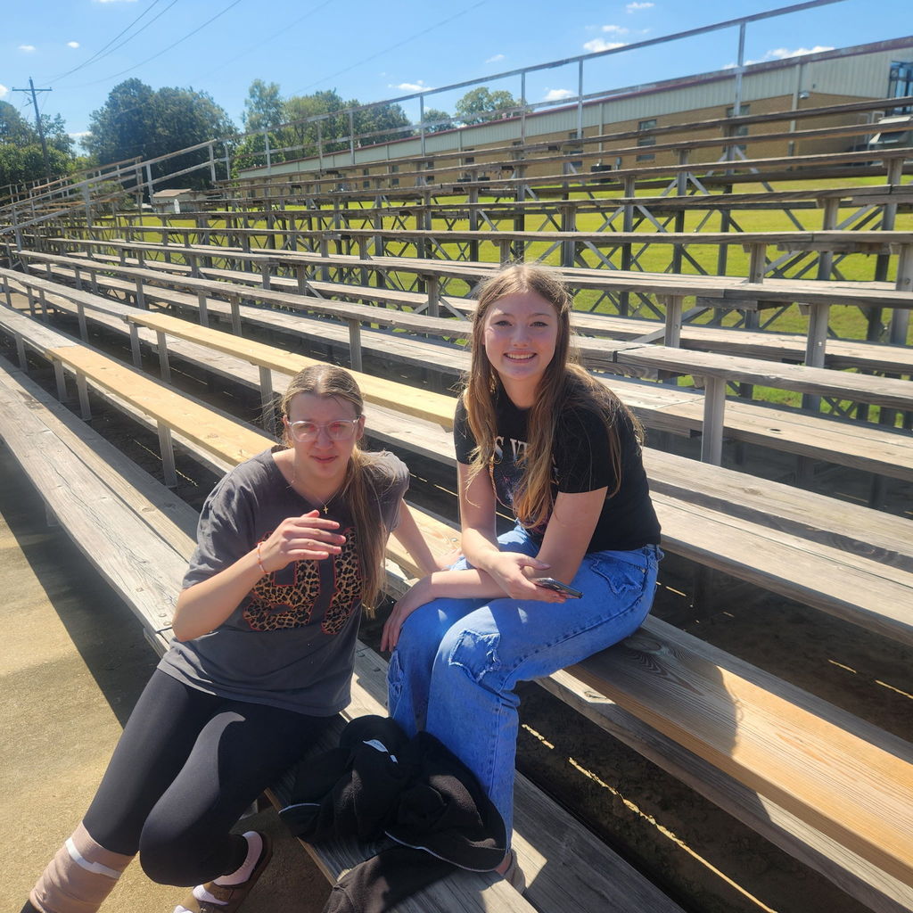 Junior high students mingling on the football field