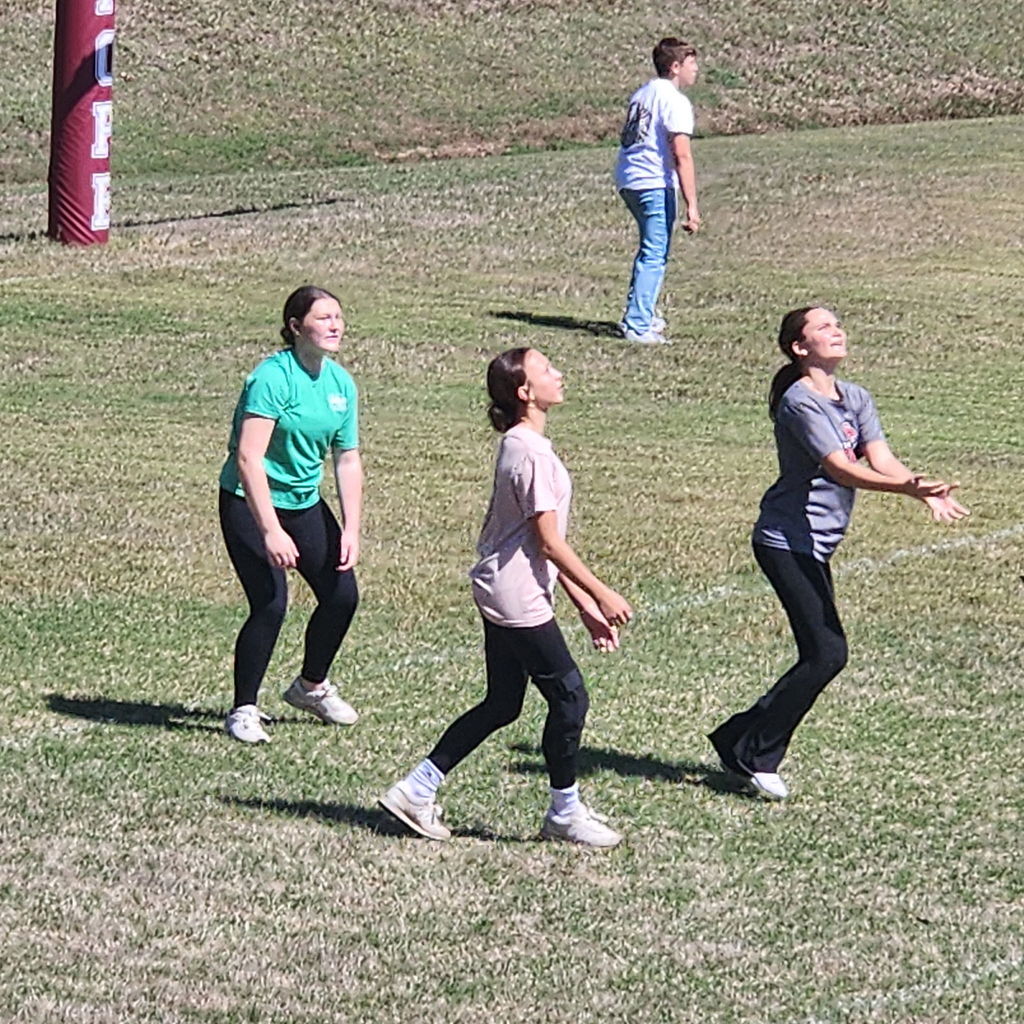 Junior high students mingling on the football field