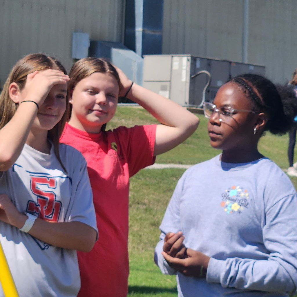 Junior high students mingling on the football field