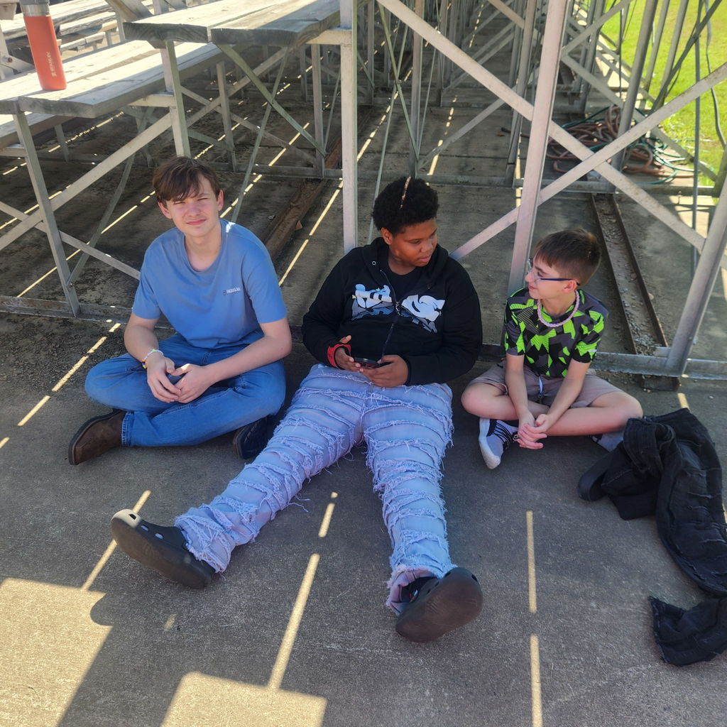 Junior high students mingling on the football field