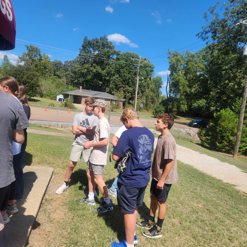 Junior high students mingling on the football field