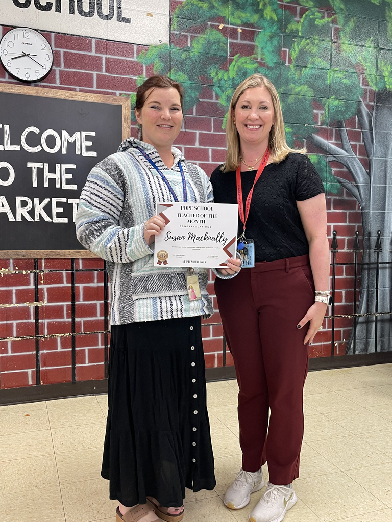 Principal and teacher standing together