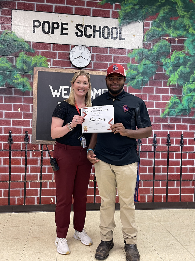 Principal and school worker standing together