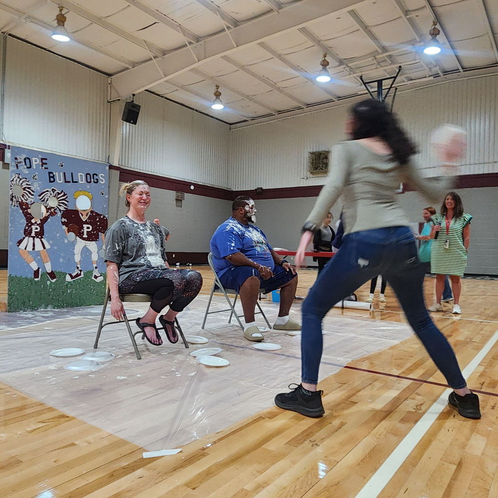 students in gymnasium stands at a pep rally