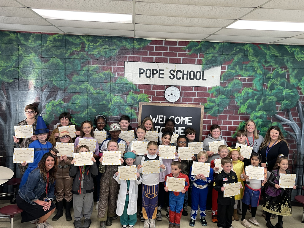 Students and teachers holding award certificates