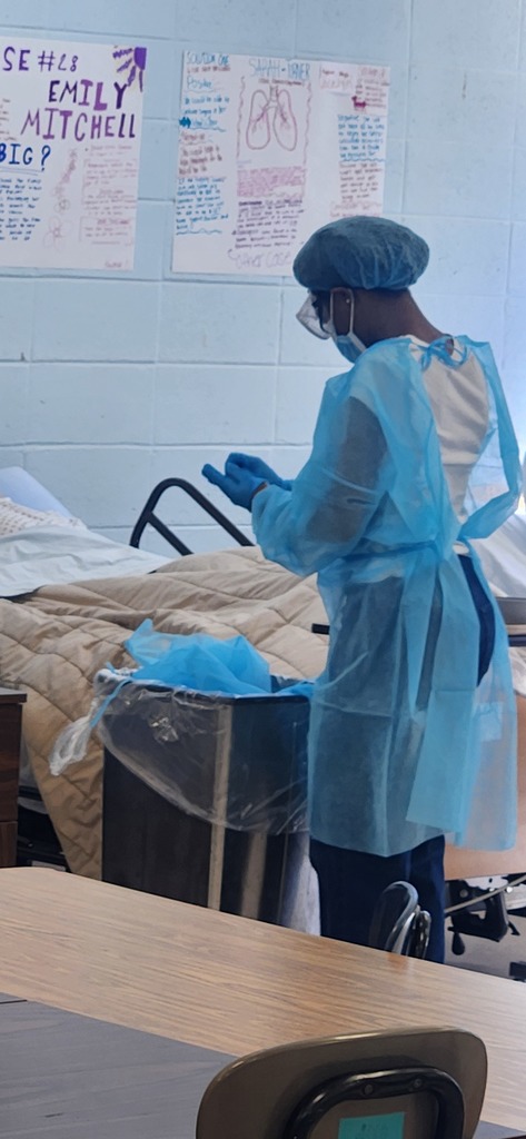 Health Science students learn how to properly don (put on) and doff (remove) personal protective equipment