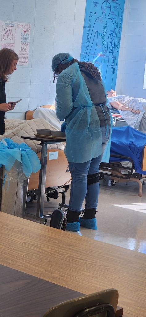 Health Science students learn how to properly don (put on) and doff (remove) personal protective equipment
