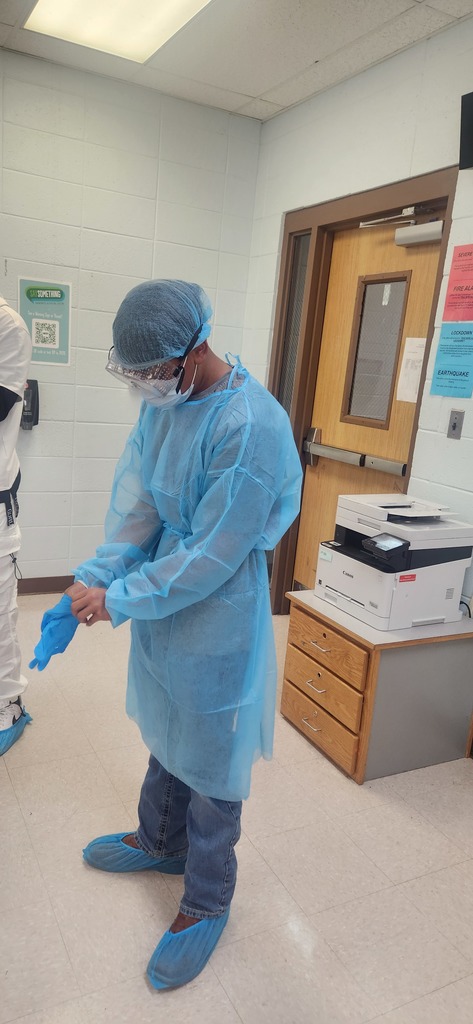 Health Science students learn how to properly don (put on) and doff (remove) personal protective equipment