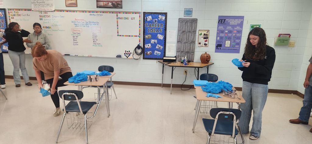 Health Science students learn how to properly don (put on) and doff (remove) personal protective equipment