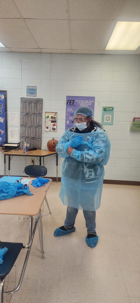 Health Science students learn how to properly don (put on) and doff (remove) personal protective equipment
