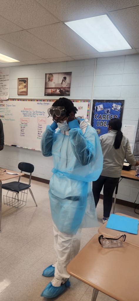 Health Science students learn how to properly don (put on) and doff (remove) personal protective equipment