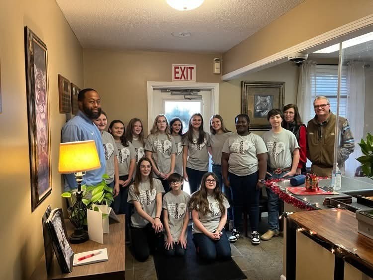 group of junior high choir students standing with faculty members