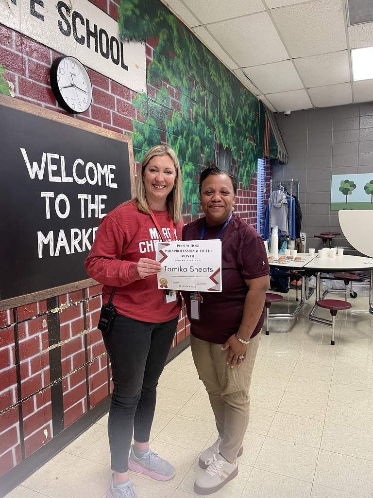 teacher and administrator holding a certificate