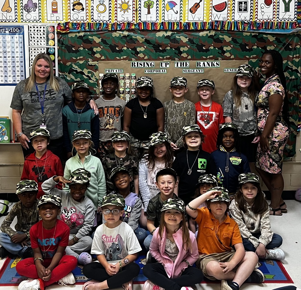 group of first graders wearing army hats