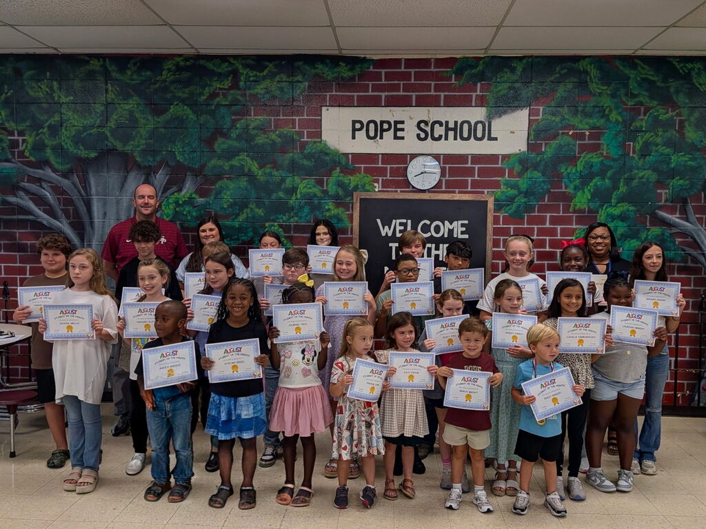 Students and teachers holding certificates