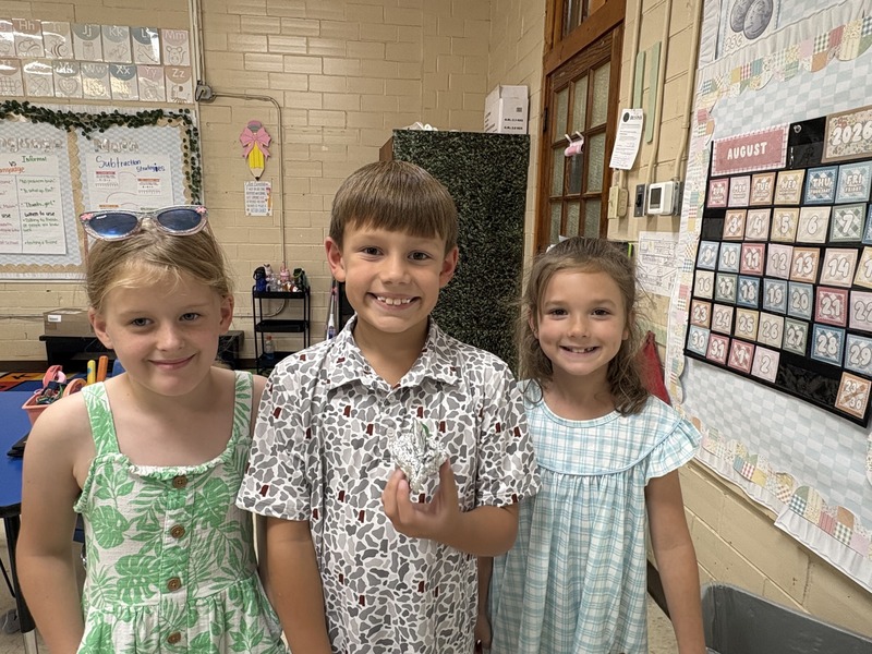 2nd  grade students working on aluminum foil boats
