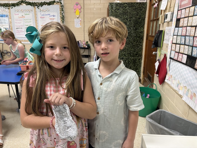 2nd  grade students working on aluminum foil boats