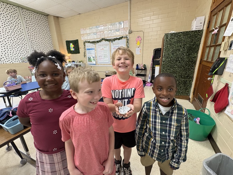 2nd  grade students working on aluminum foil boats