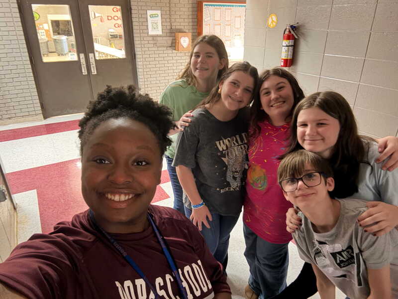 Choir teacher standing with students
