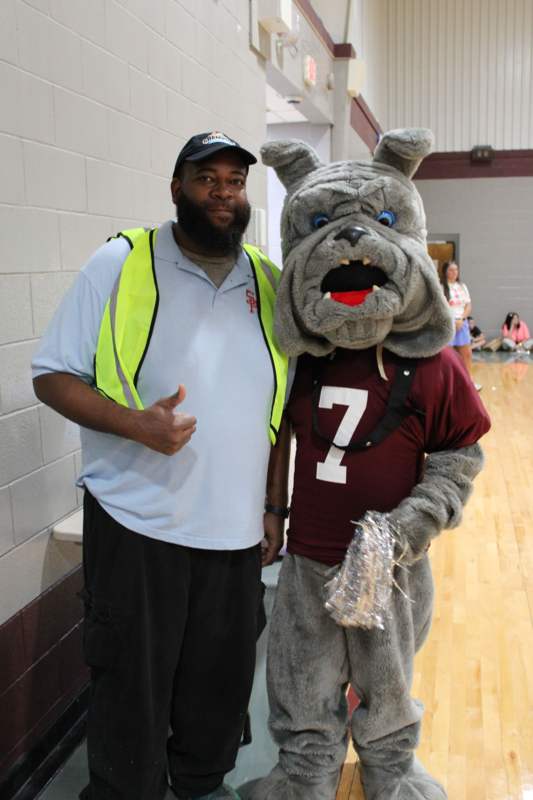 Bulldog mascot standing with man