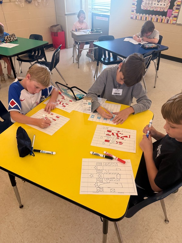 4th grade students working on a craft