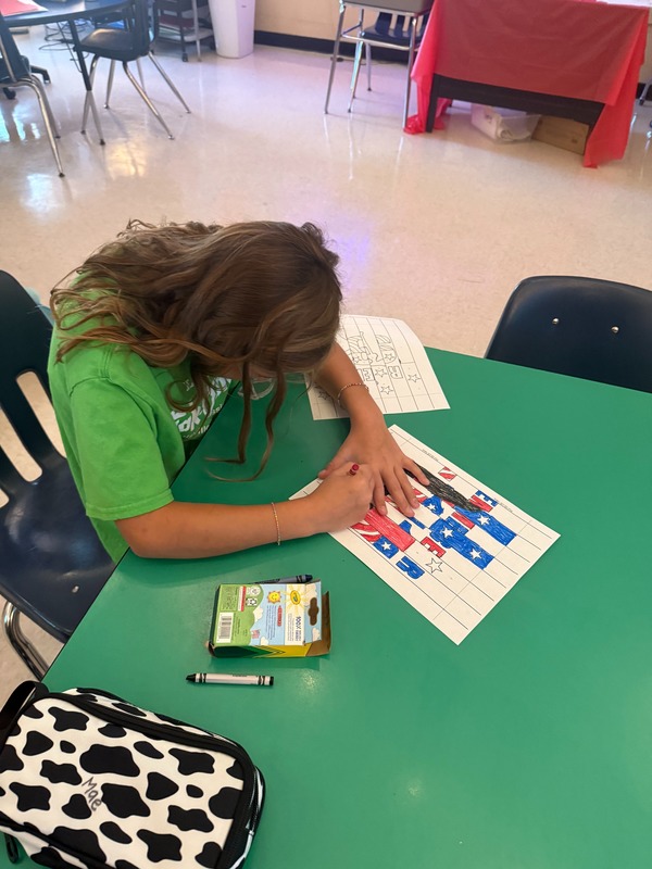 4th grade students working on a craft