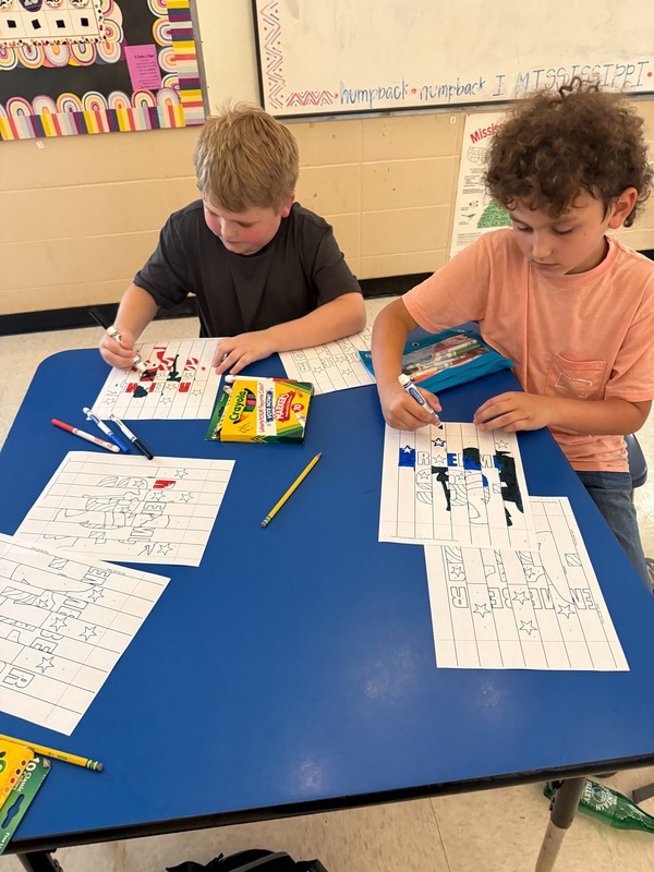 4th grade students working on a craft