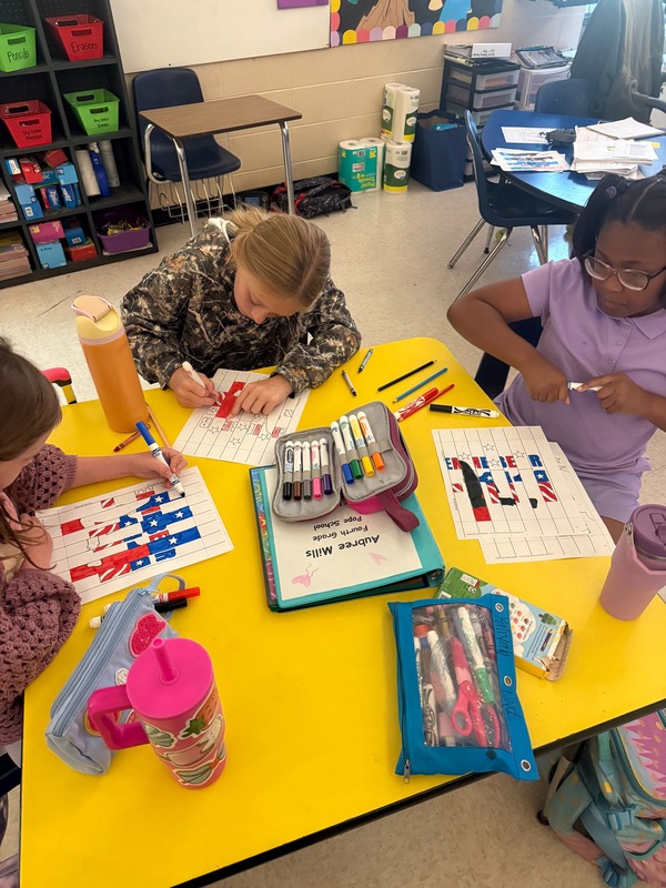 4th grade students working on a craft