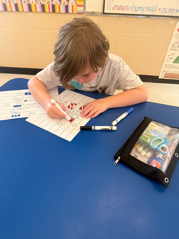 4th grade students working on a craft