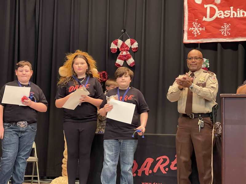 student essay winners holding certificates
