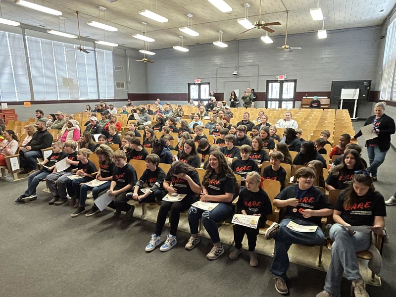 group of 5th grade students in auditorium seats